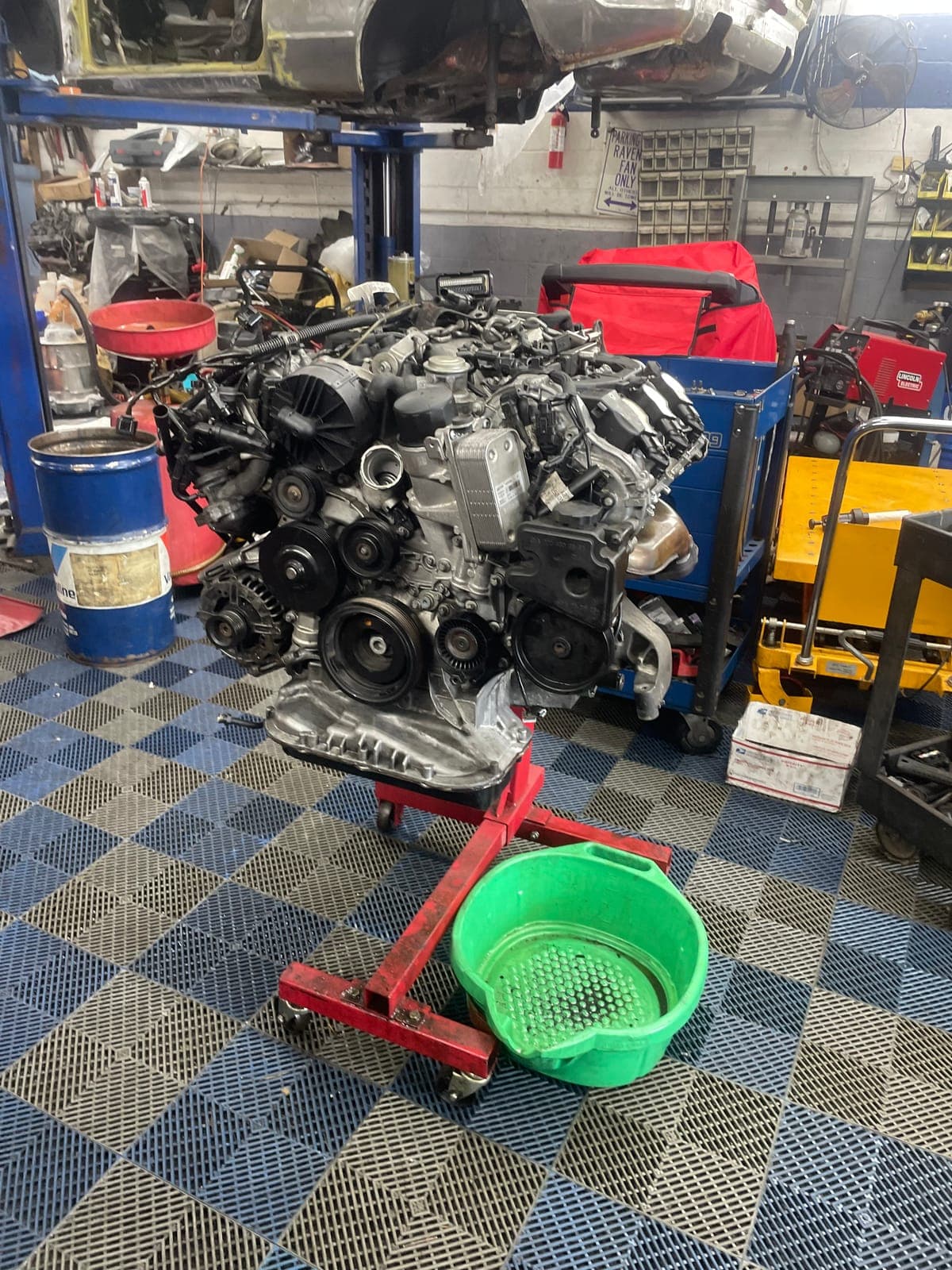 Engine on hoist with pulleys exposed